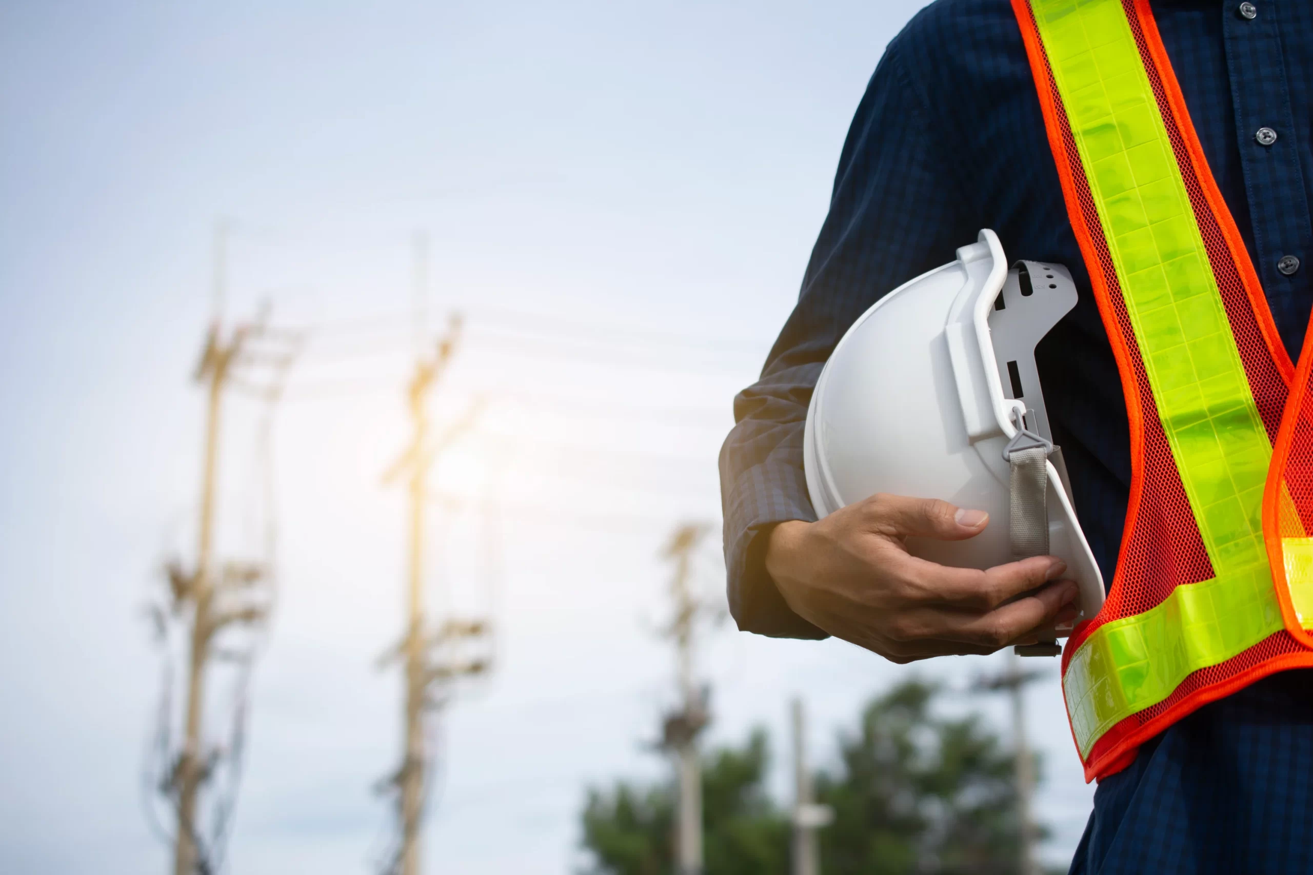 engineering-holds-white-safety-hats-and-electric-pole-background